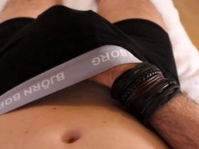 Boy plays with hard cock in boxers