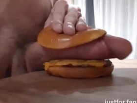 Muscular horny teen fucks a burger with a big dick and cums in it